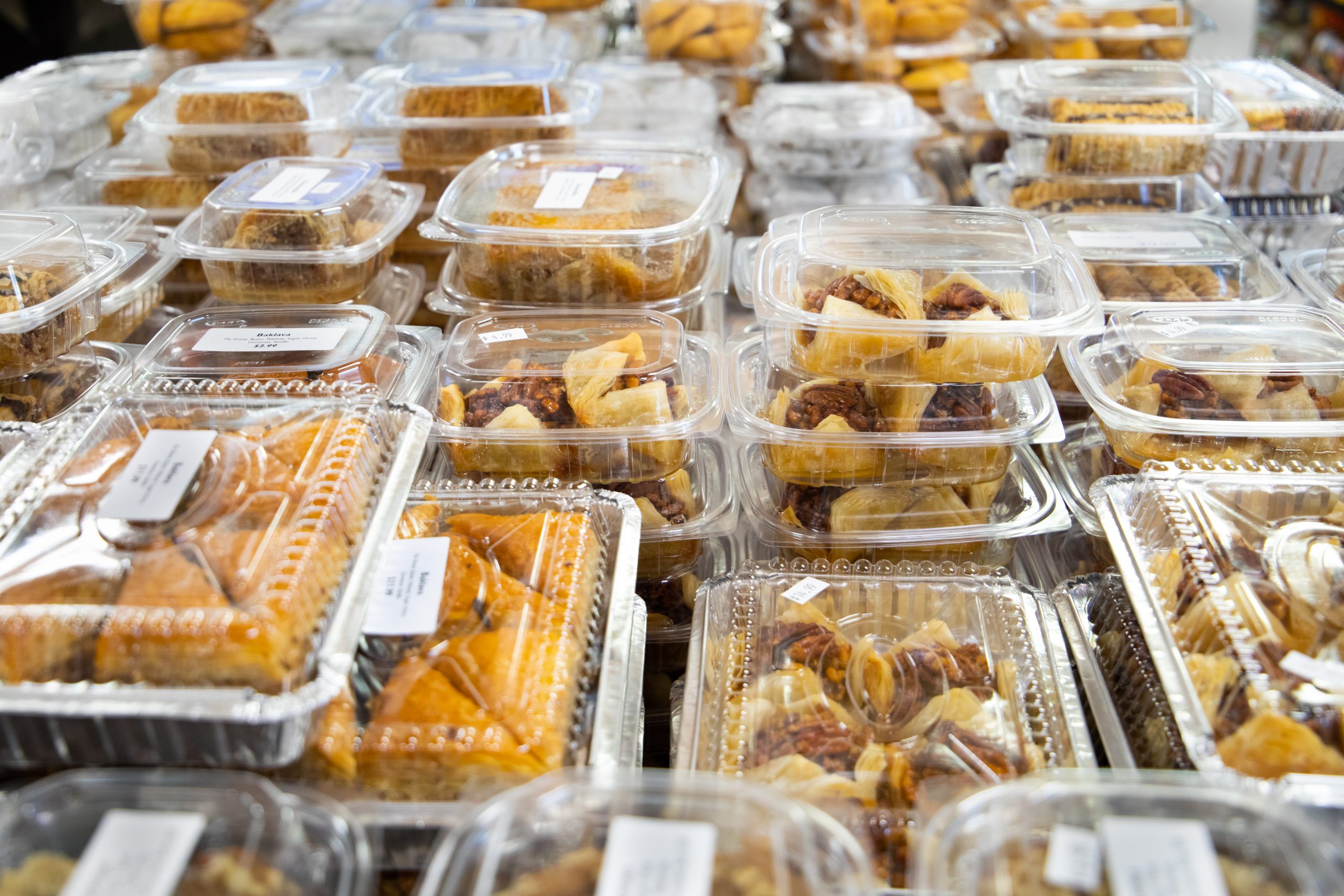 Many plastic containers of hand made desserts