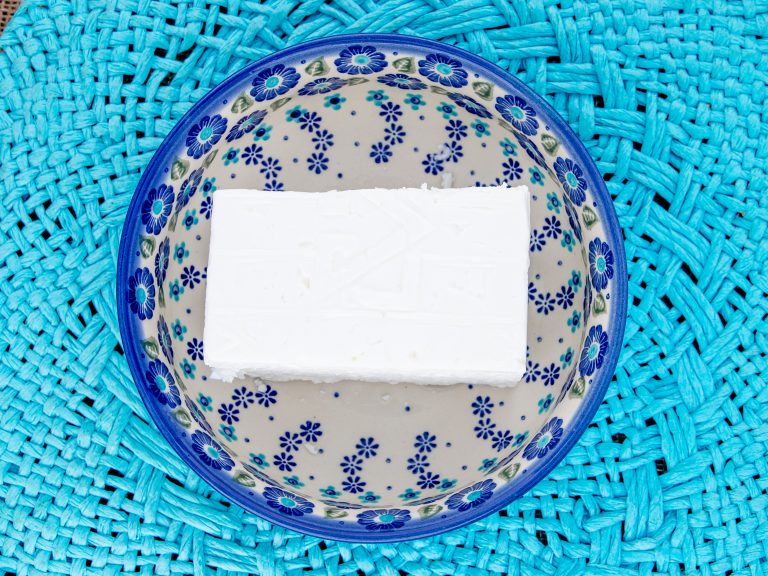 Block of feta cheese in bowl
